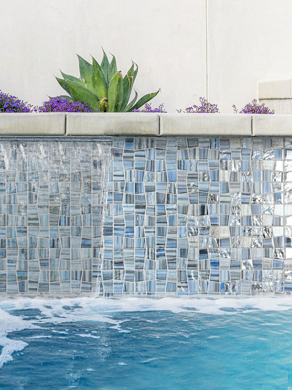 Glass mosaic pool tile installed at the waterline