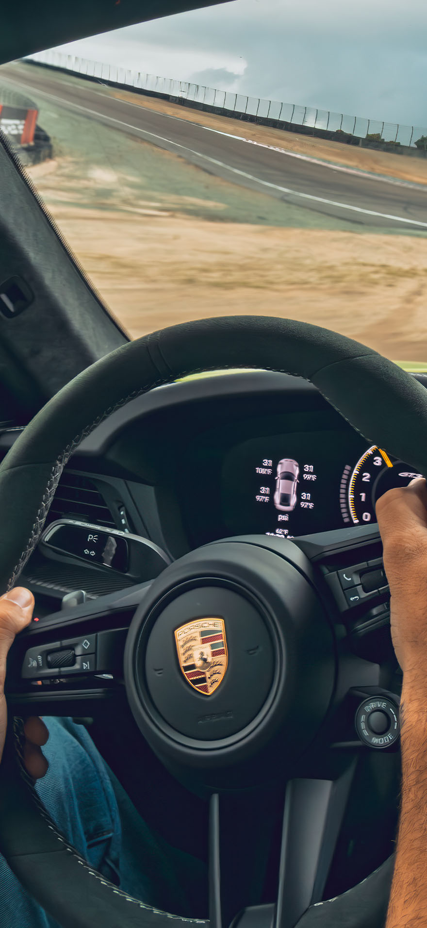 Porsche sports car driving on a track.