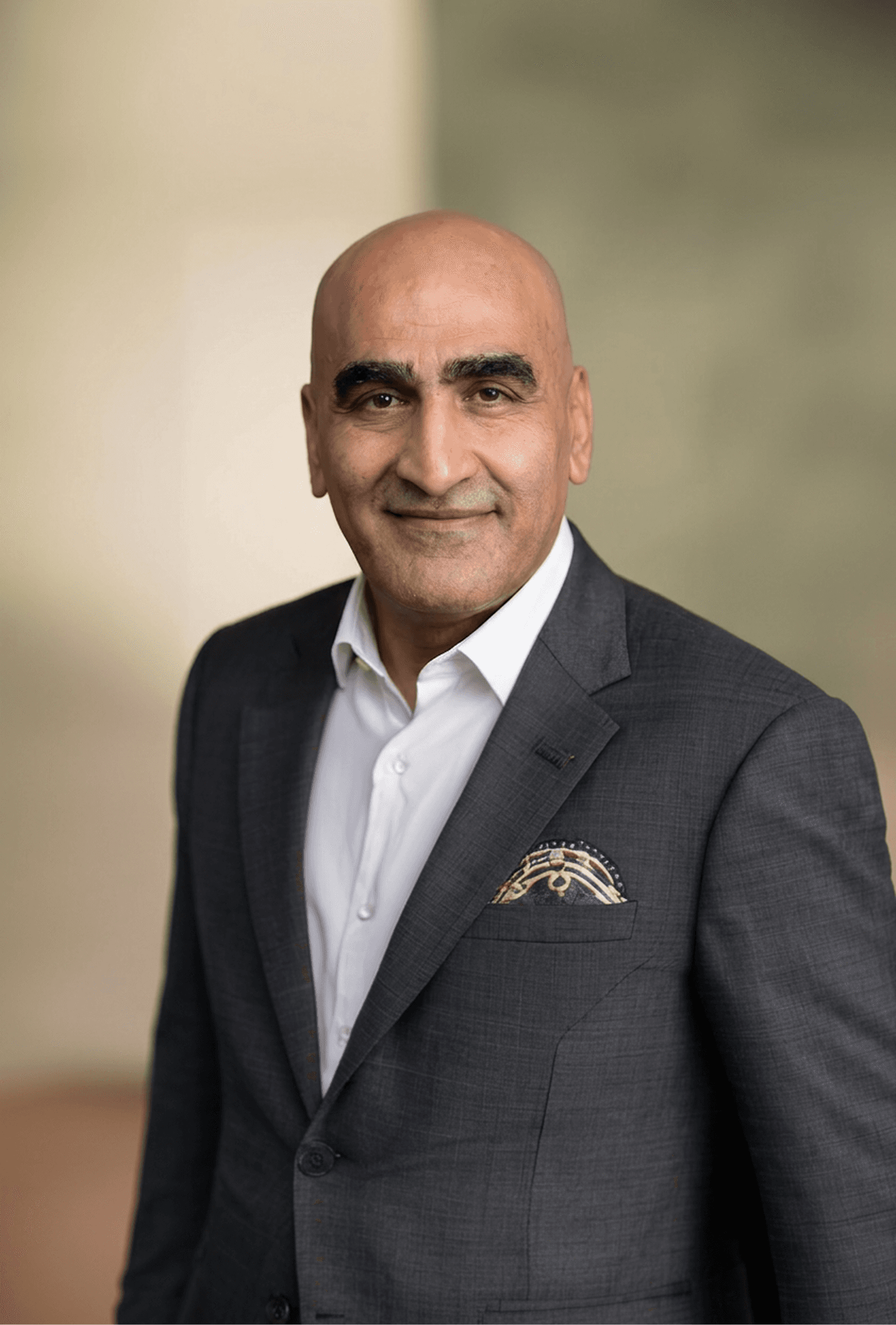 a man in a blue shirt smiling at the camera