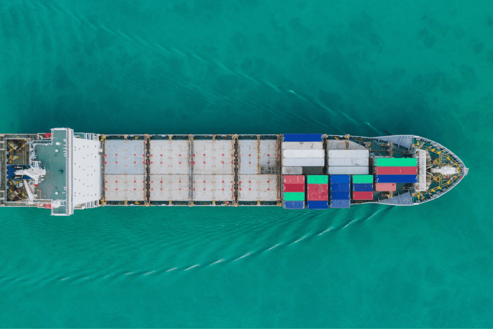 Half filled shipping container moving across the ocean