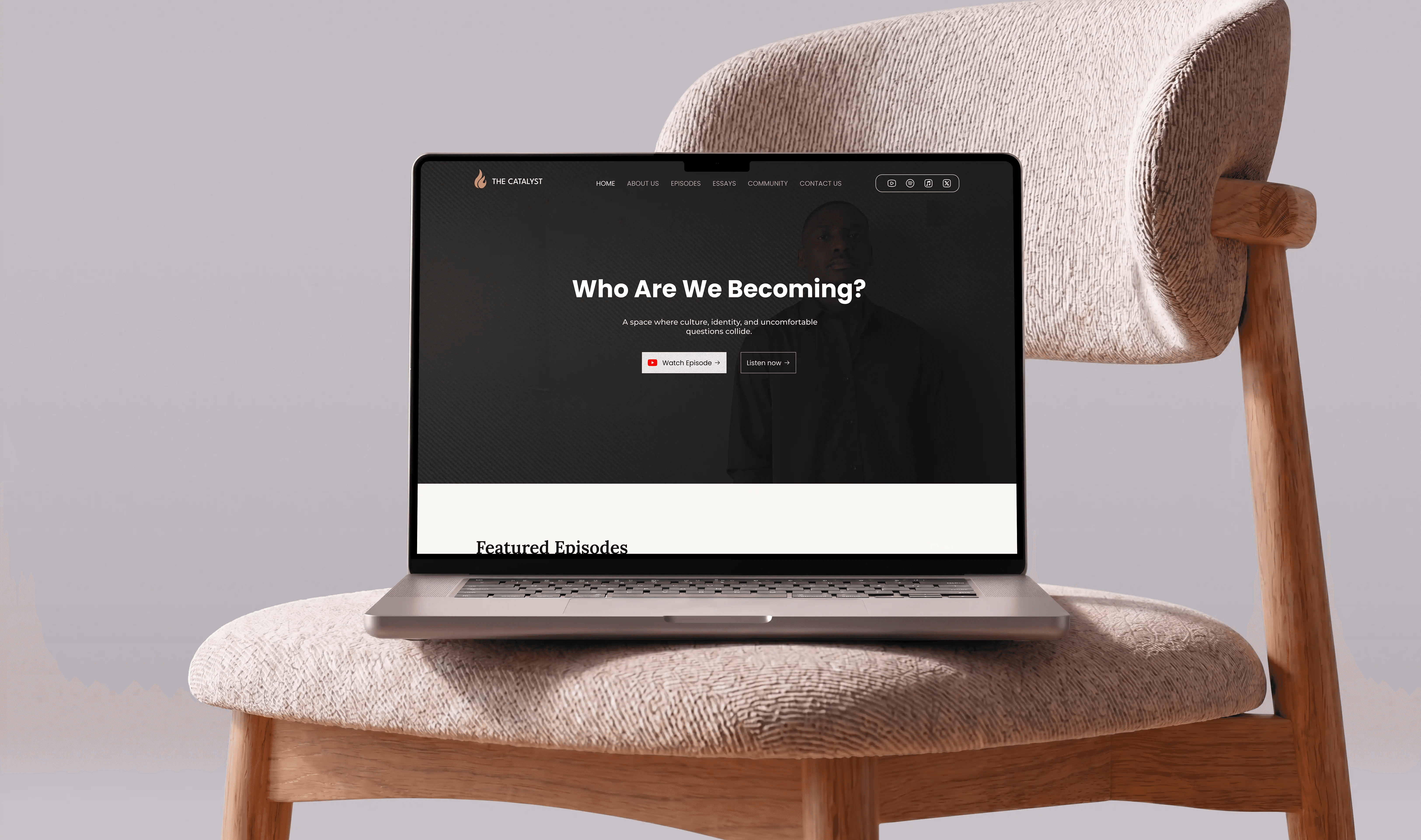 The catalyst website display on a laptop and placed on a biege cushion with a plain backgound