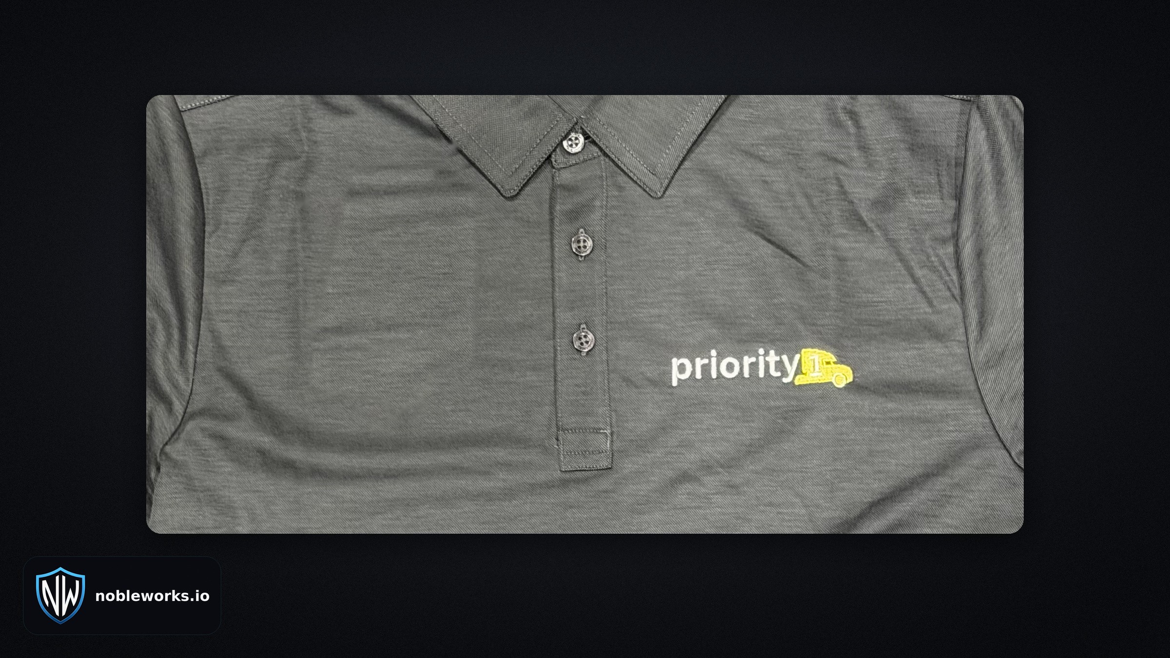 Priority 1 logo embroidered on the left chest of a gray polo