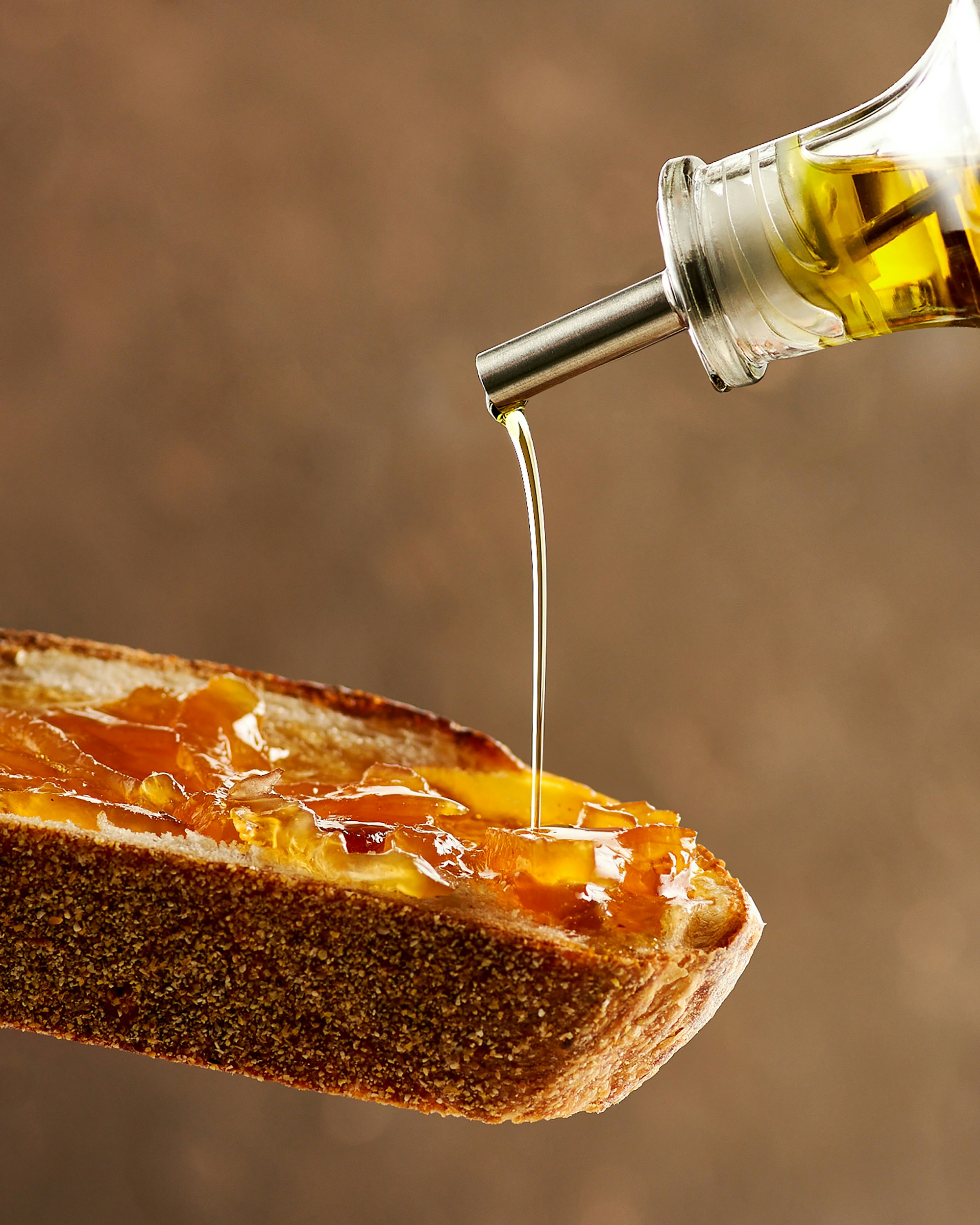 Olive oil poured over toasted bread