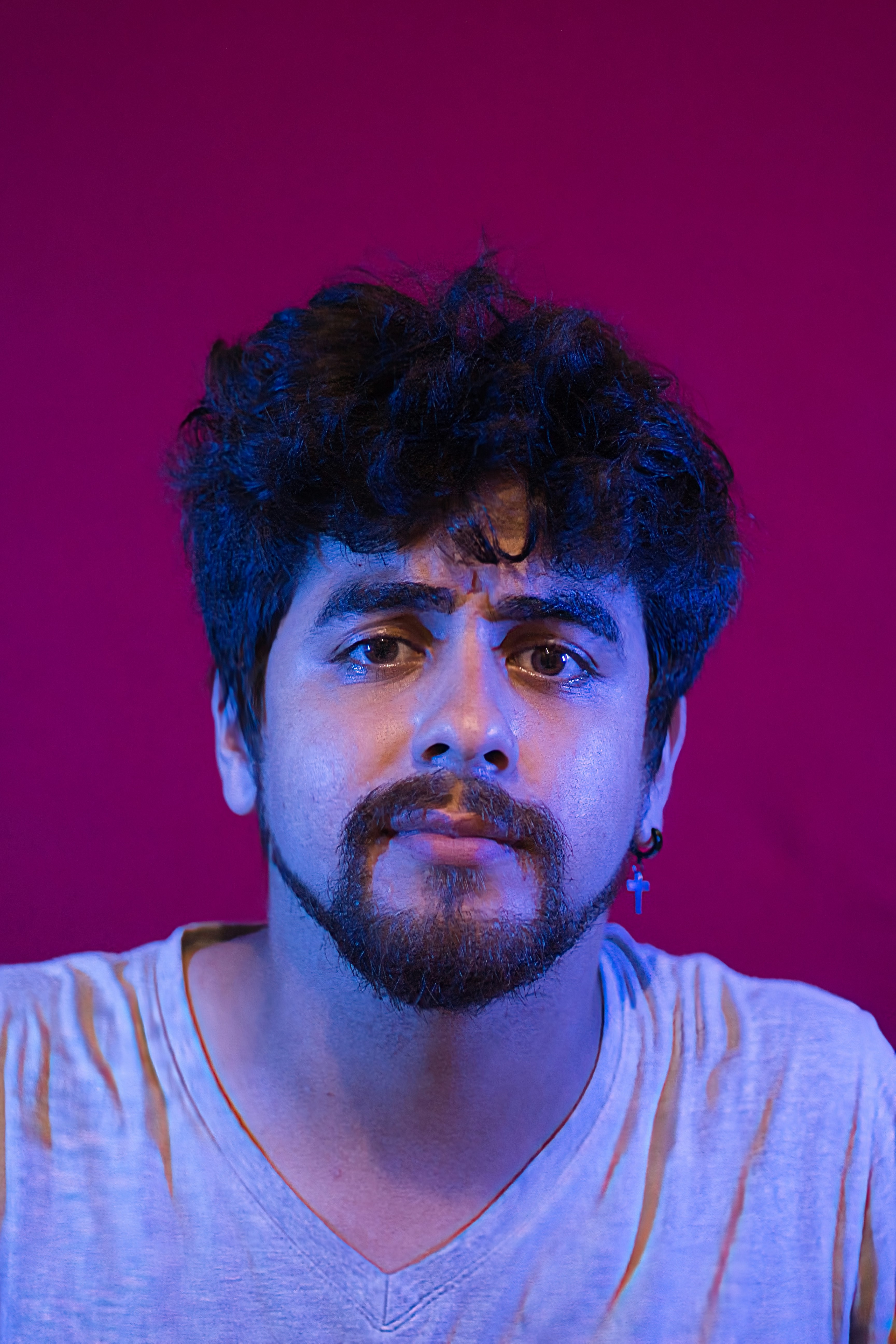 A man with a beard poses for the camera.