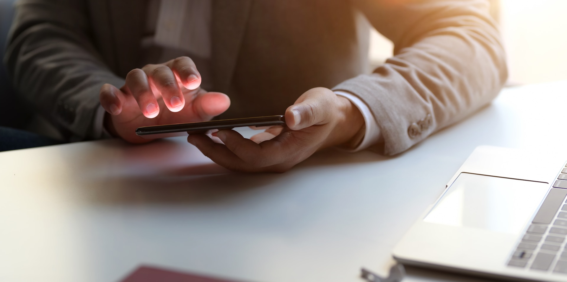 A person holding a phone while sitting