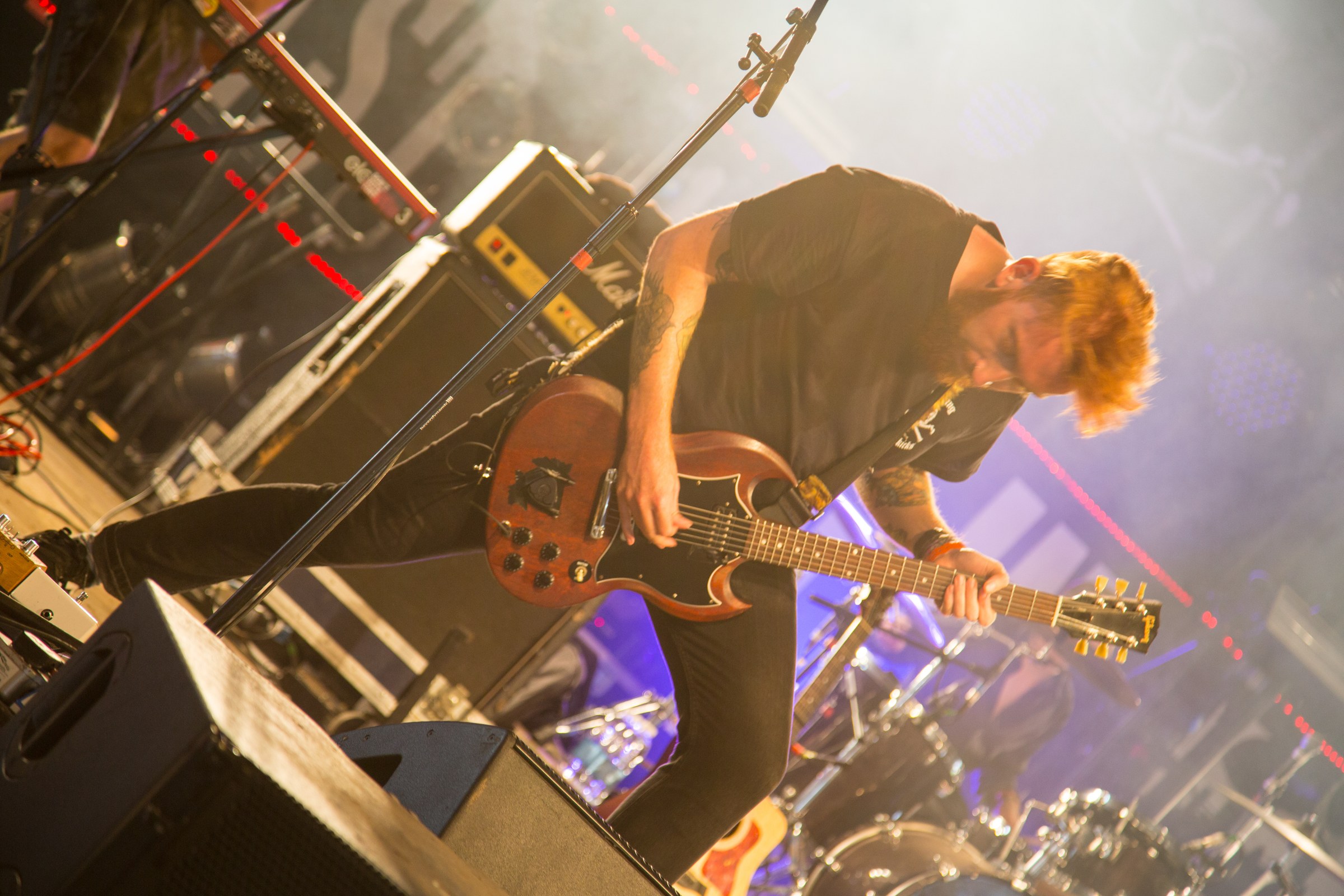 EVENTS · A guitarist caught in the warm stage lights.
