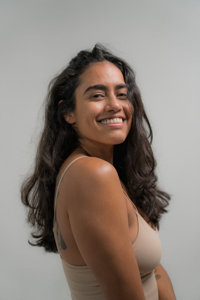 Woman in White Tank Top Smiling