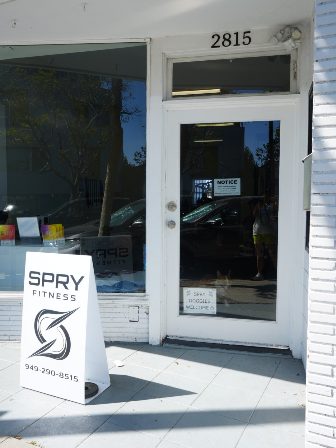 Rachel, personal trainer, looking to the side confidently in a fitness studio