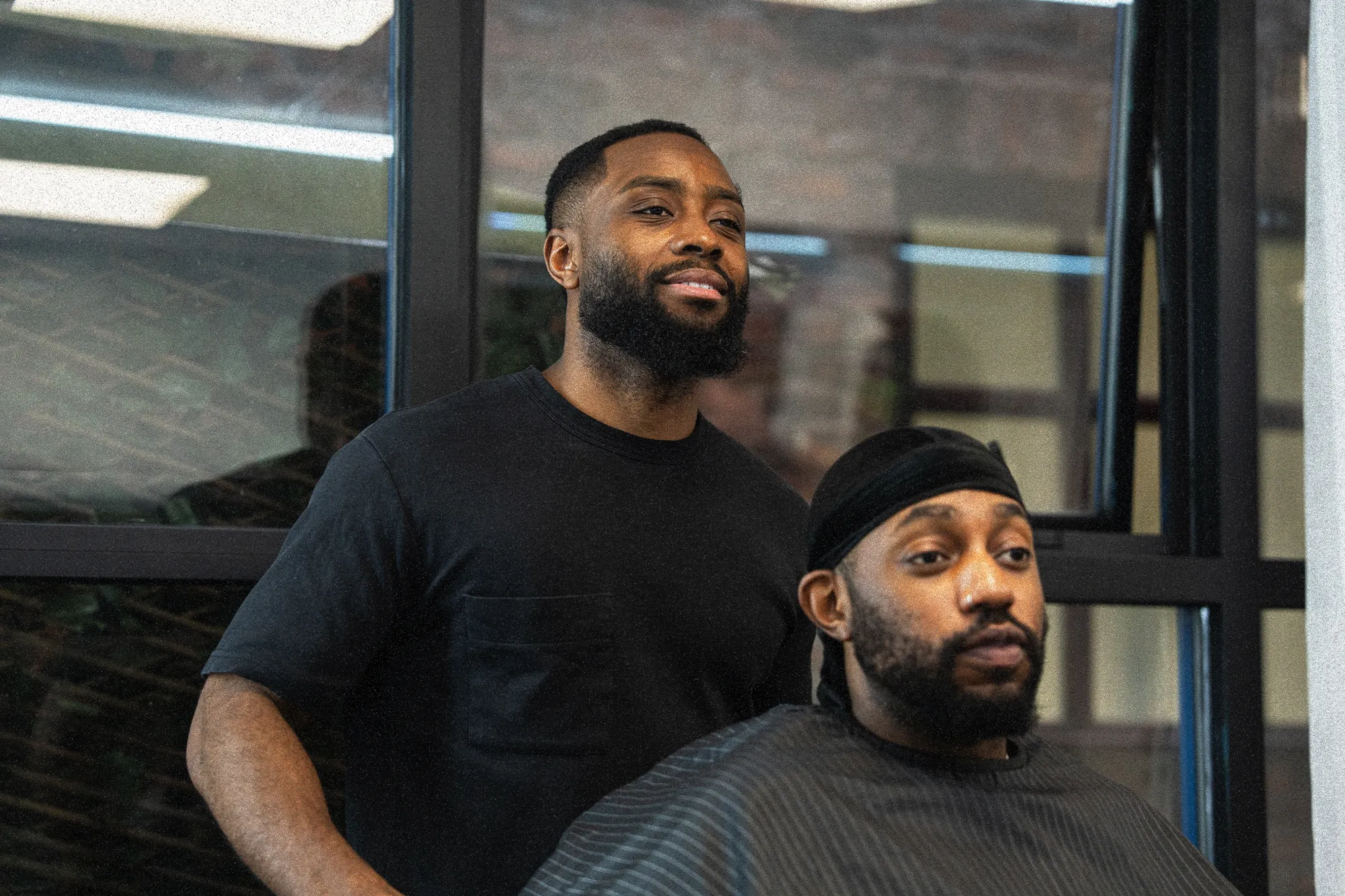 Barber Smiling with Client.