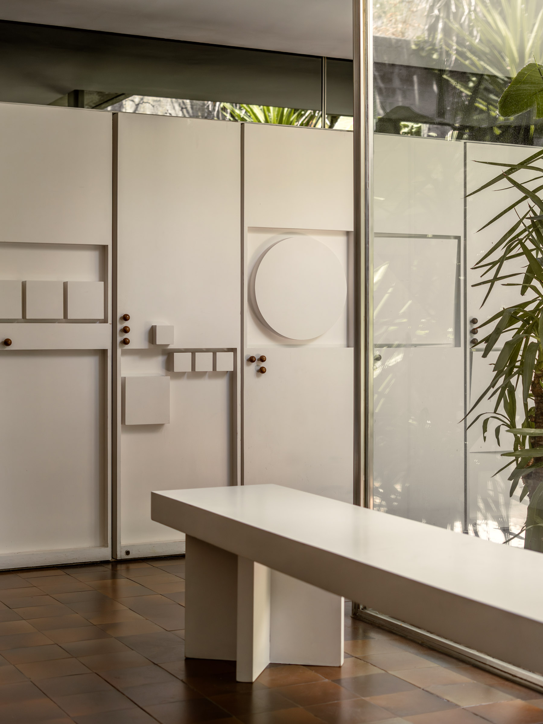 Interior passage with a sculptural doorway and exposed concrete walls at Casa Carvajal.