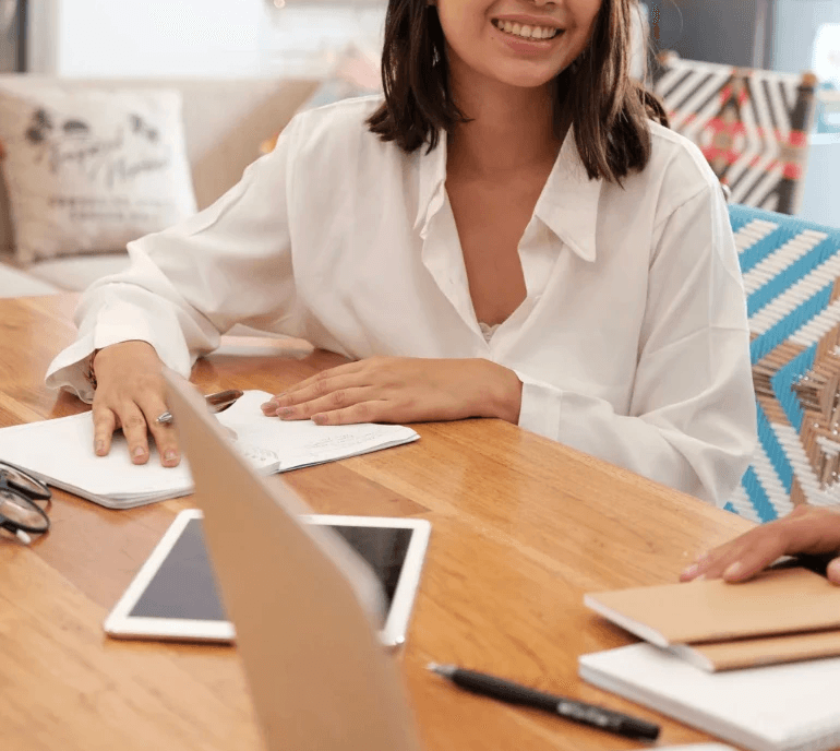 A cozy scene with warm sunlight casting stripes, featuring a potted plant and soft towels on a window sill.