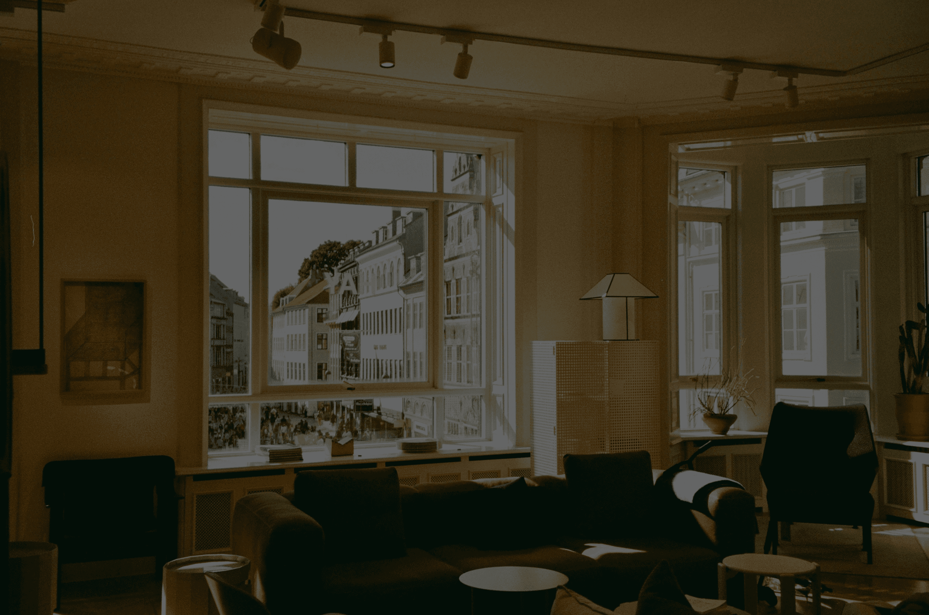 Blurry cityscape with red light and street lights at night.