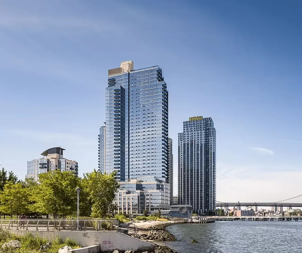 The New York riverfront bustling with tourists enjoying the scenic views and vibrant atmosphere along the water.