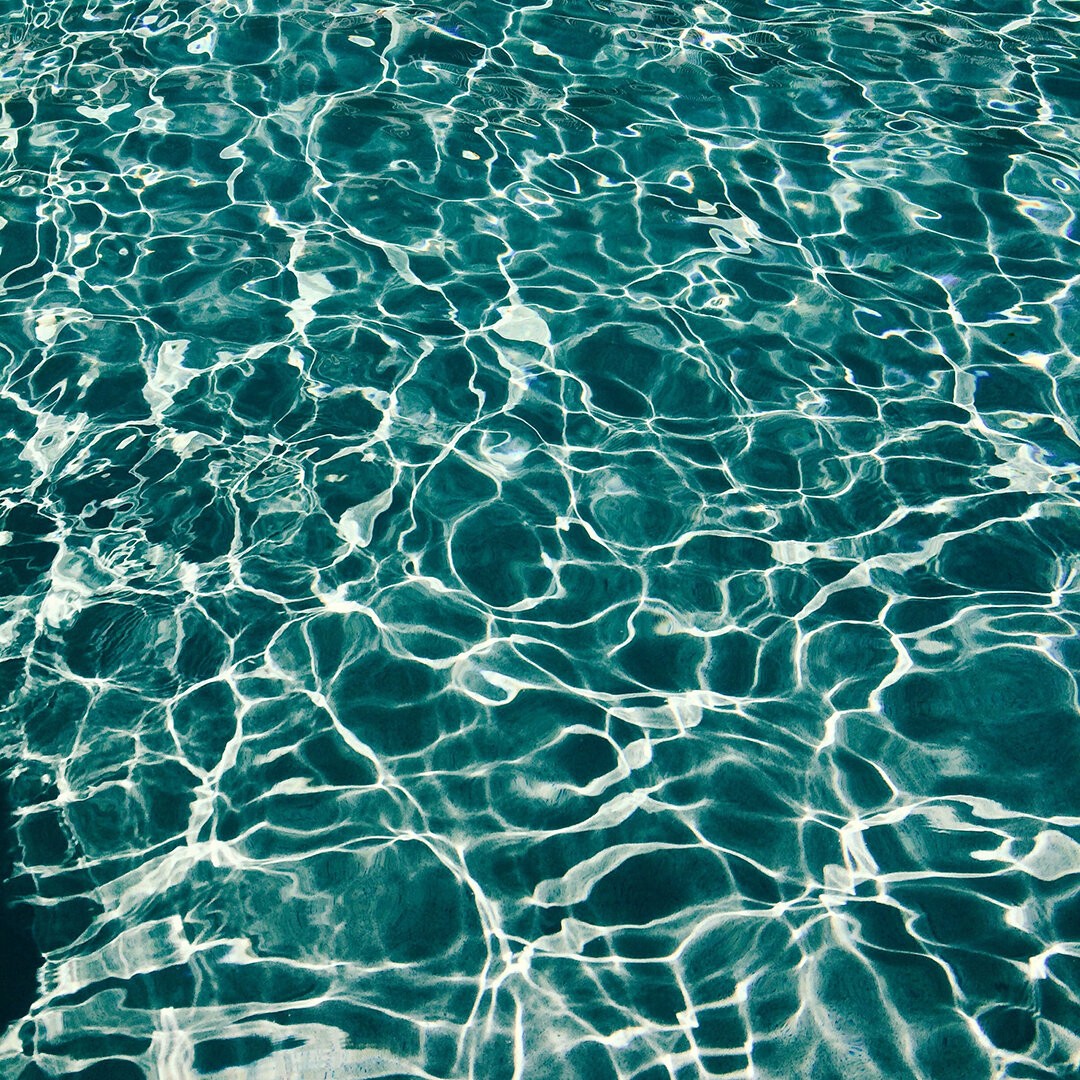 Sunlight on rippling turquoise water, representing the water element