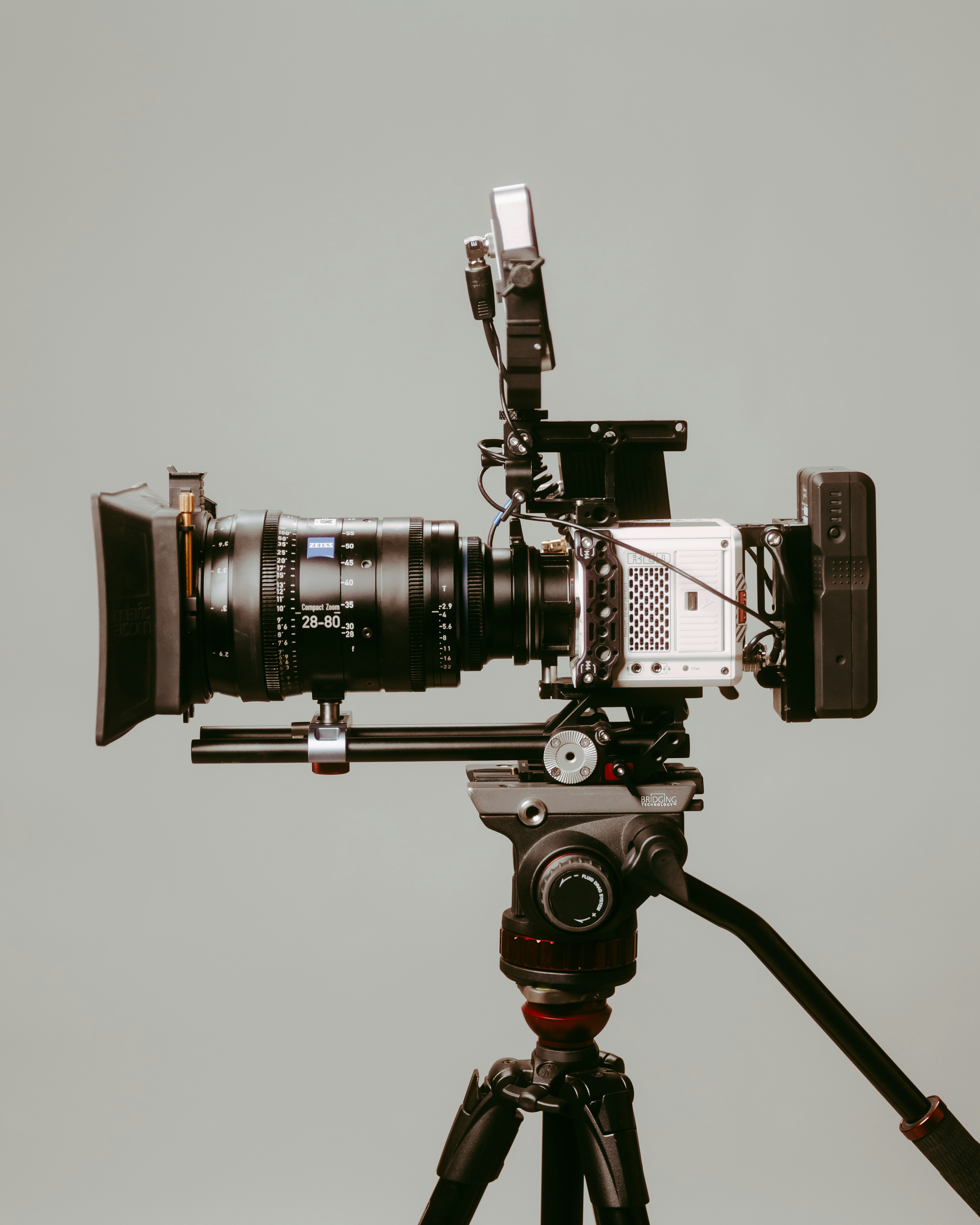 black and silver cinema RED camera on tripod