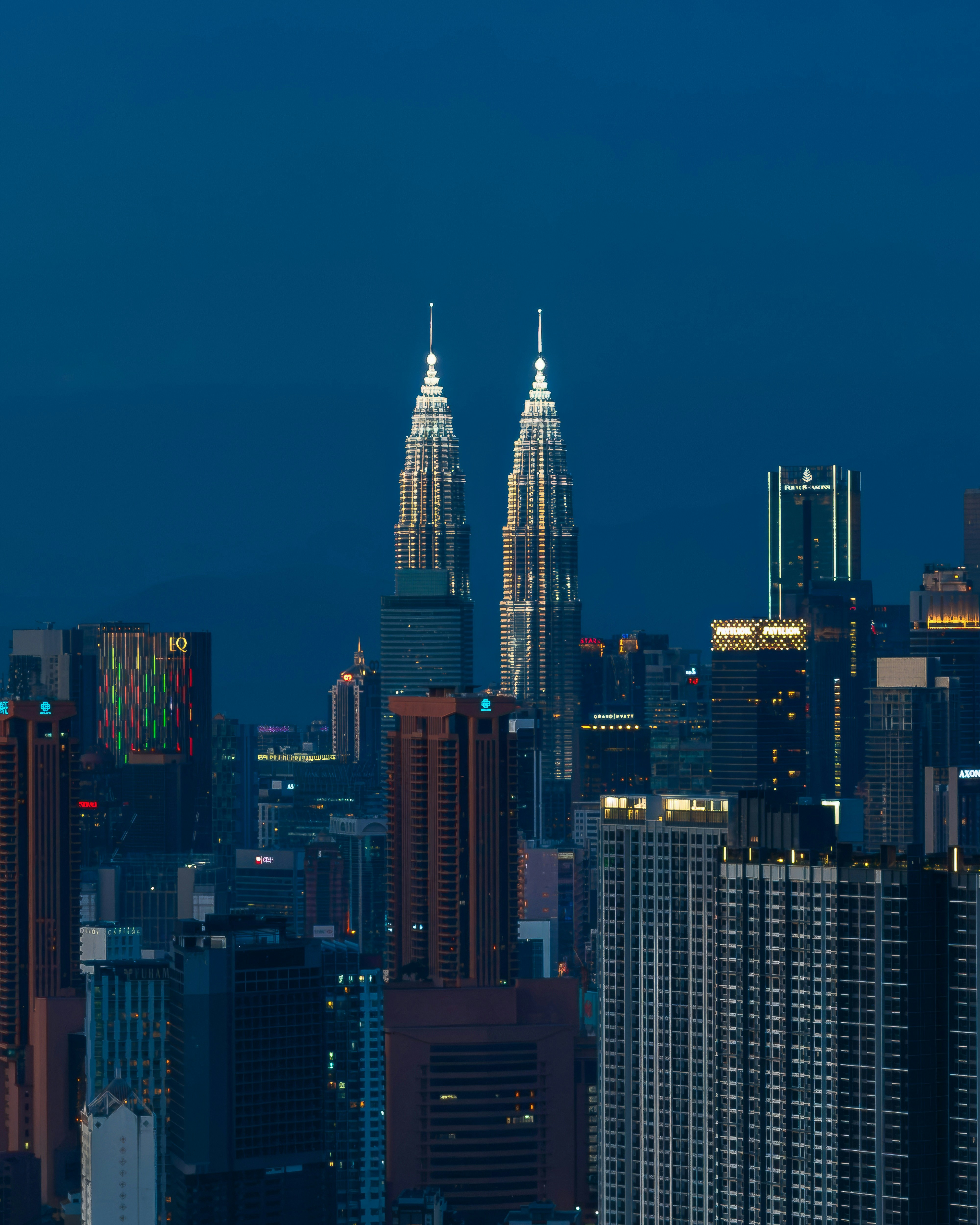 Twin towers illuminated against the night sky