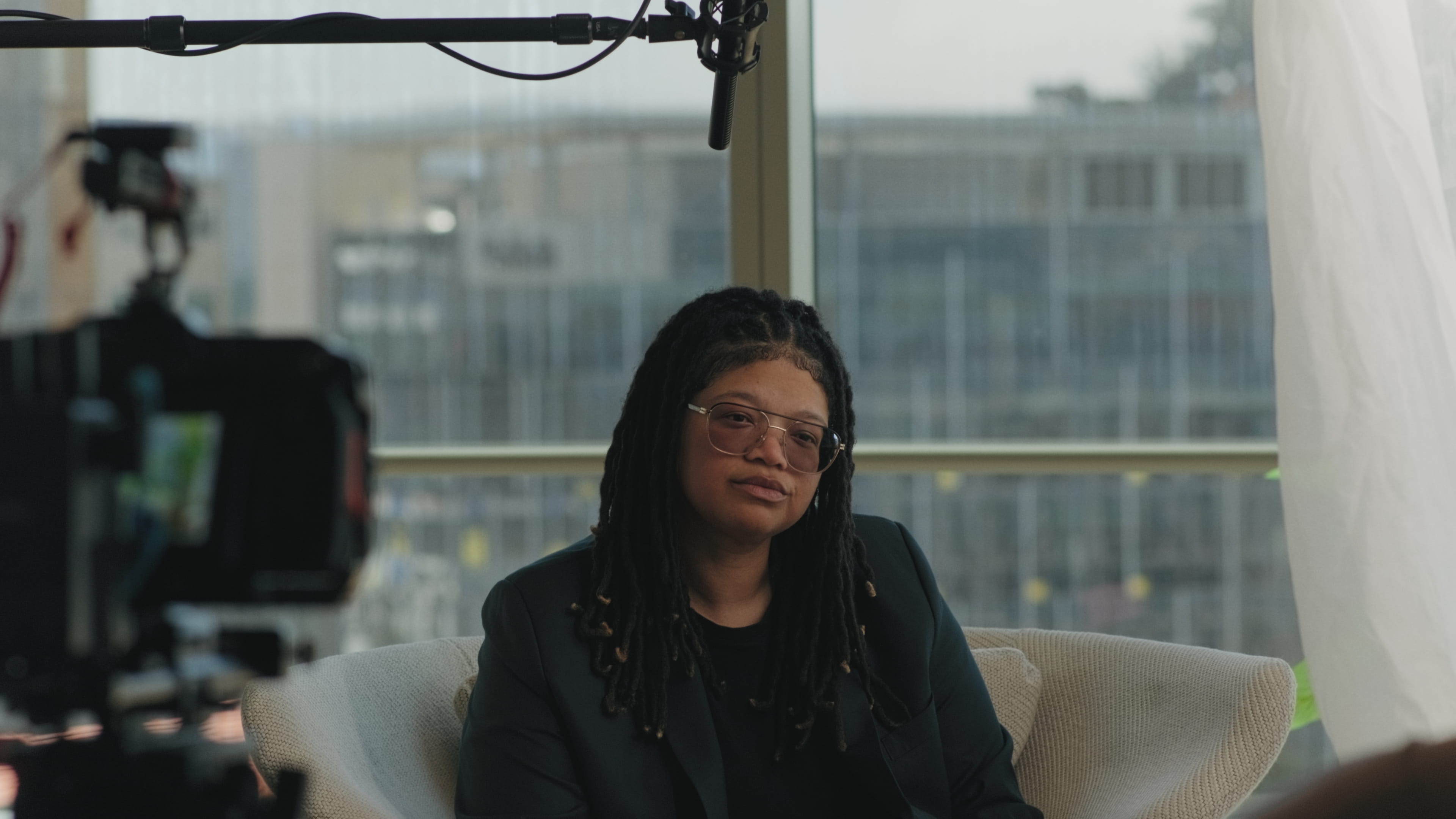 woman seated during an interview with camera and microphone visible at uber