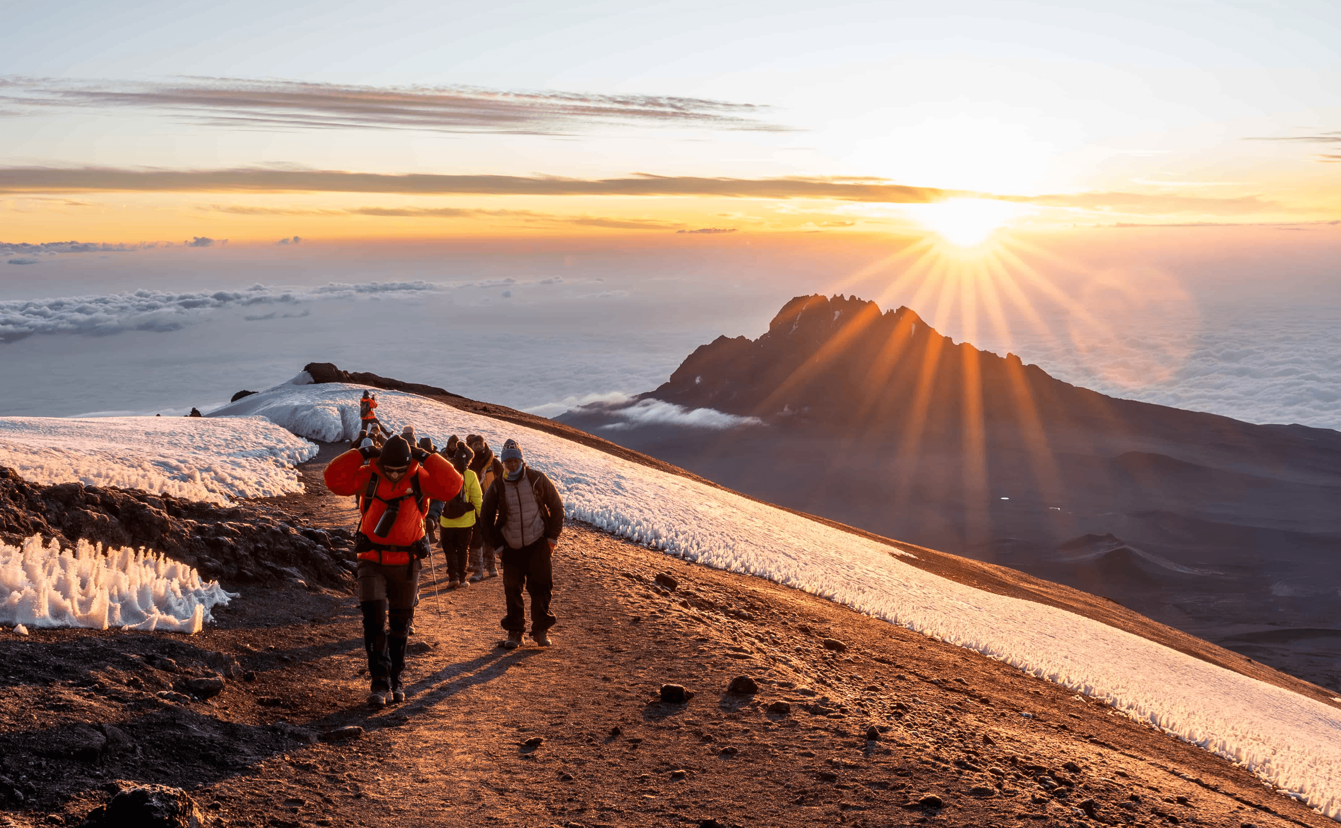 Legend Expeditions climbers approaching the Kilimanjaro summit, the kind of trip made easier by shorter UK transit times.