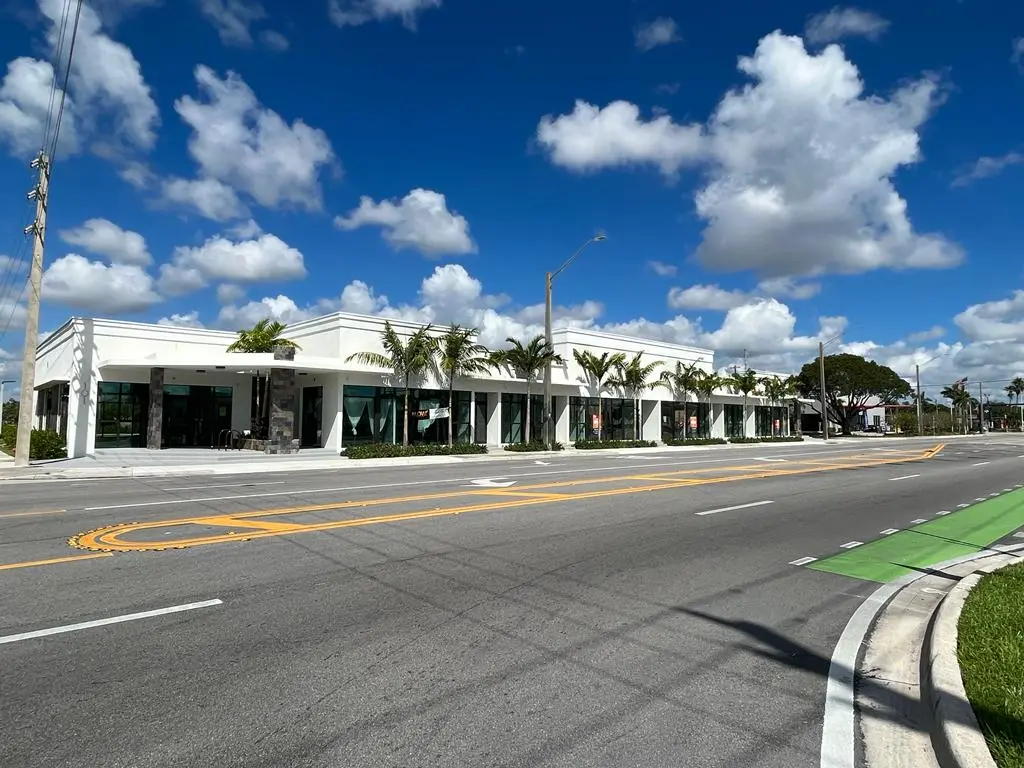 Street view of completed modern retail center with palm trees, Fort Lauderdale Florida