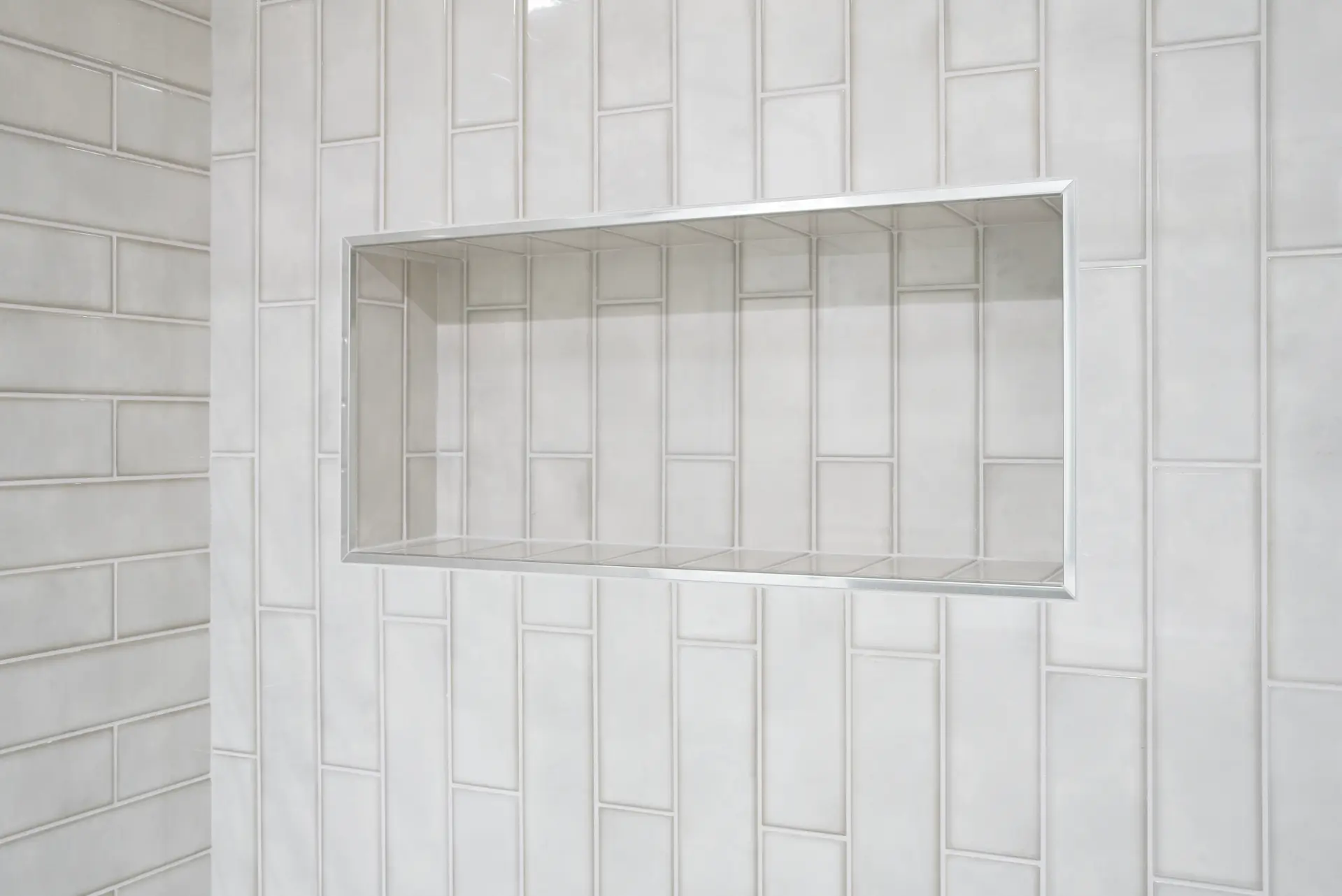 Close-up of the Jack and Jill bathroom's shower niche, a perfect blend of design and functionality, enhancing the bathing experience in the Dana Point Full Remodel. Photo by Todd Huge.