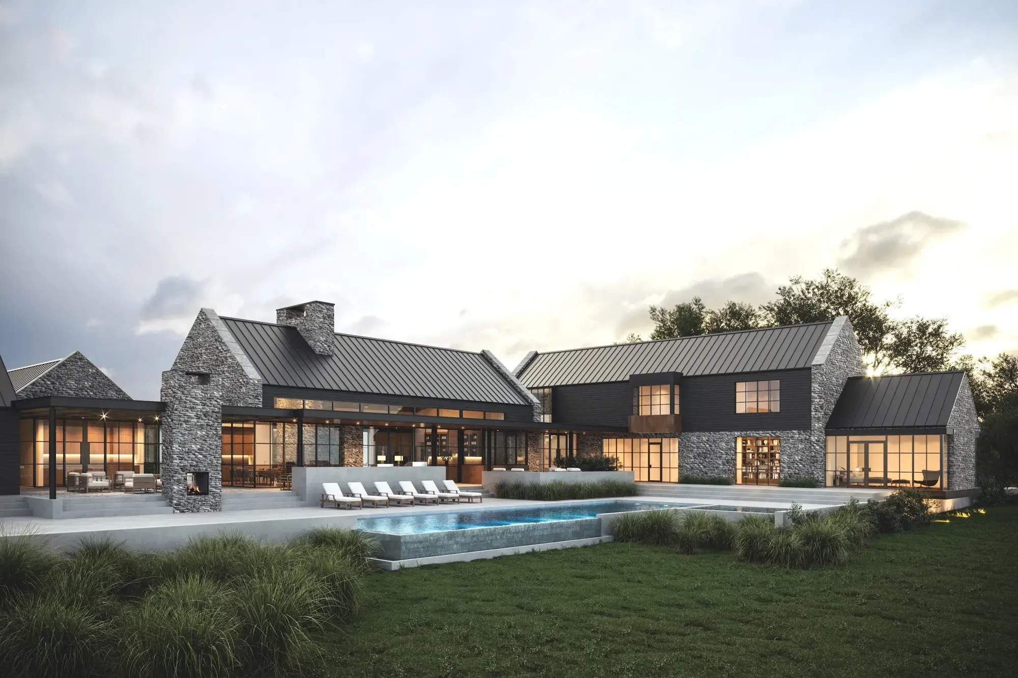 Modern white house with metal roof surrounded by lush green landscaping.