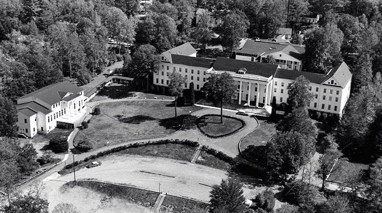 two women sitting beside table and talking