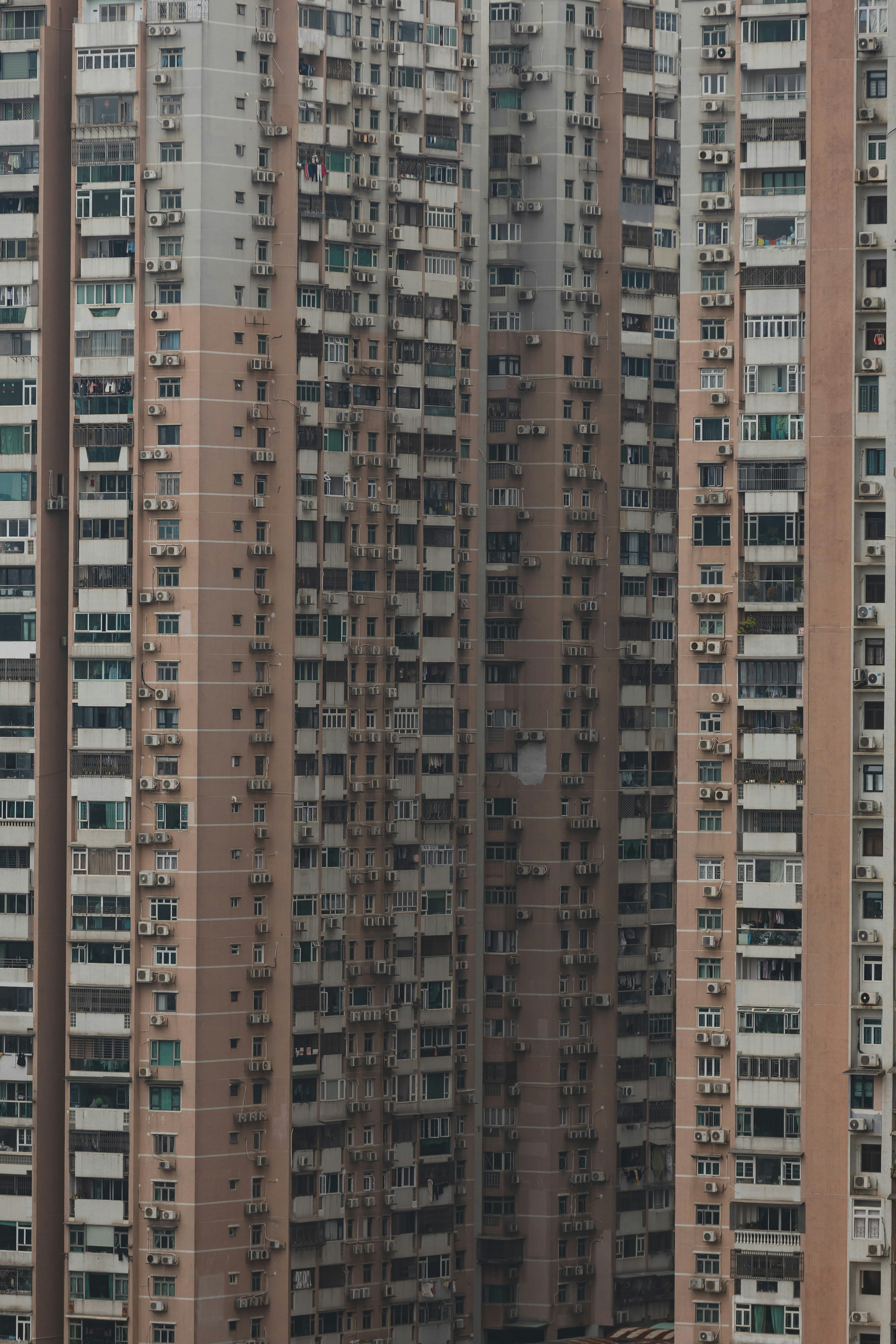 Tall apartment building with many windows and balconies
