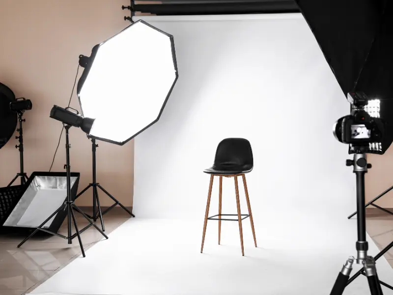 A photo studio set up with lights, a backdrop and a camera