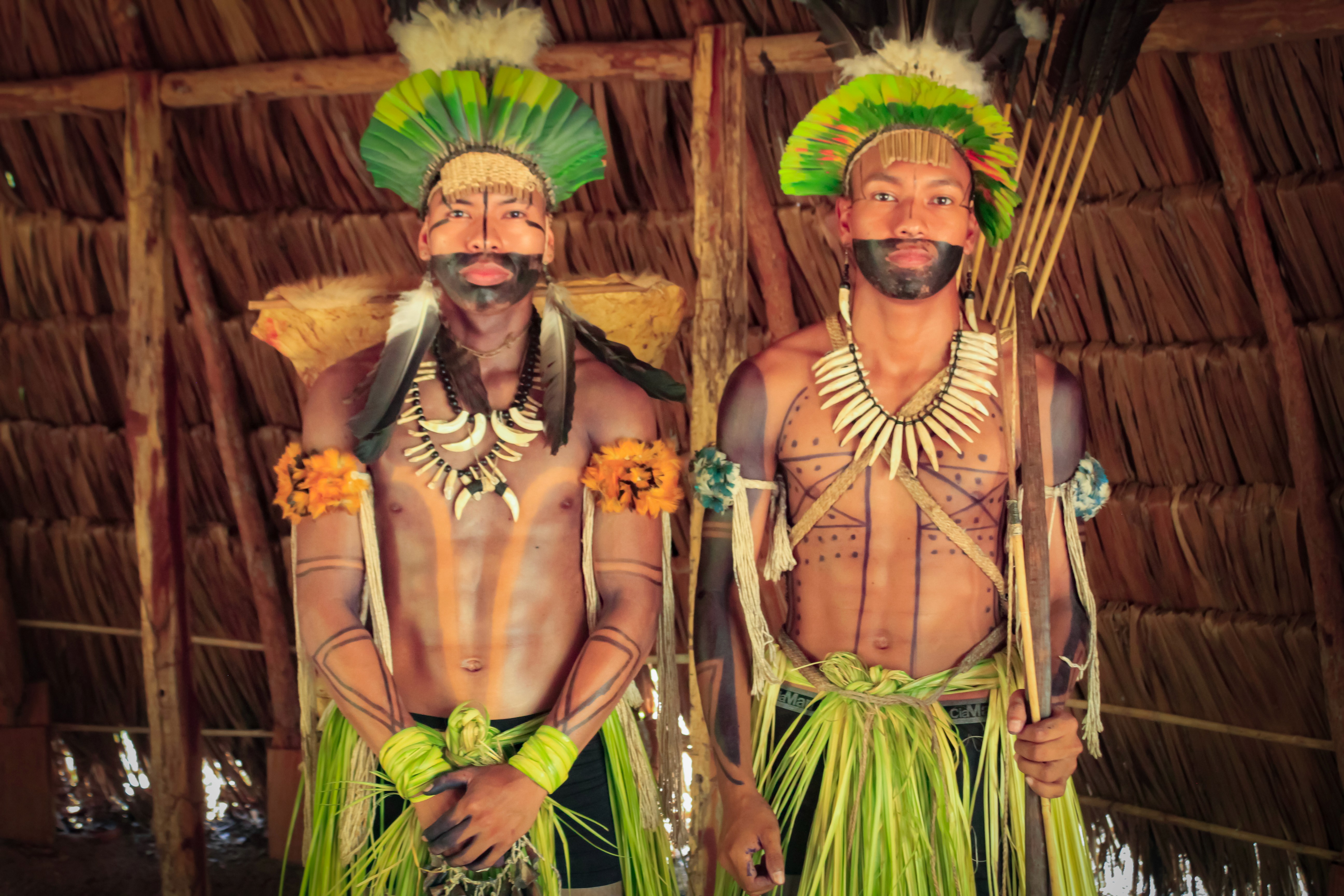 Two members of the indigenous Balatiponé Umutina people in traditional dress, photographed in their reserve near Barra do Bugres – an authentic part of the “Sources of the Pantanal” travel experience.