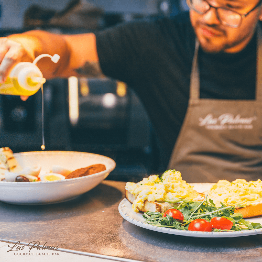 a glass of cocktail with a slime orange fruit