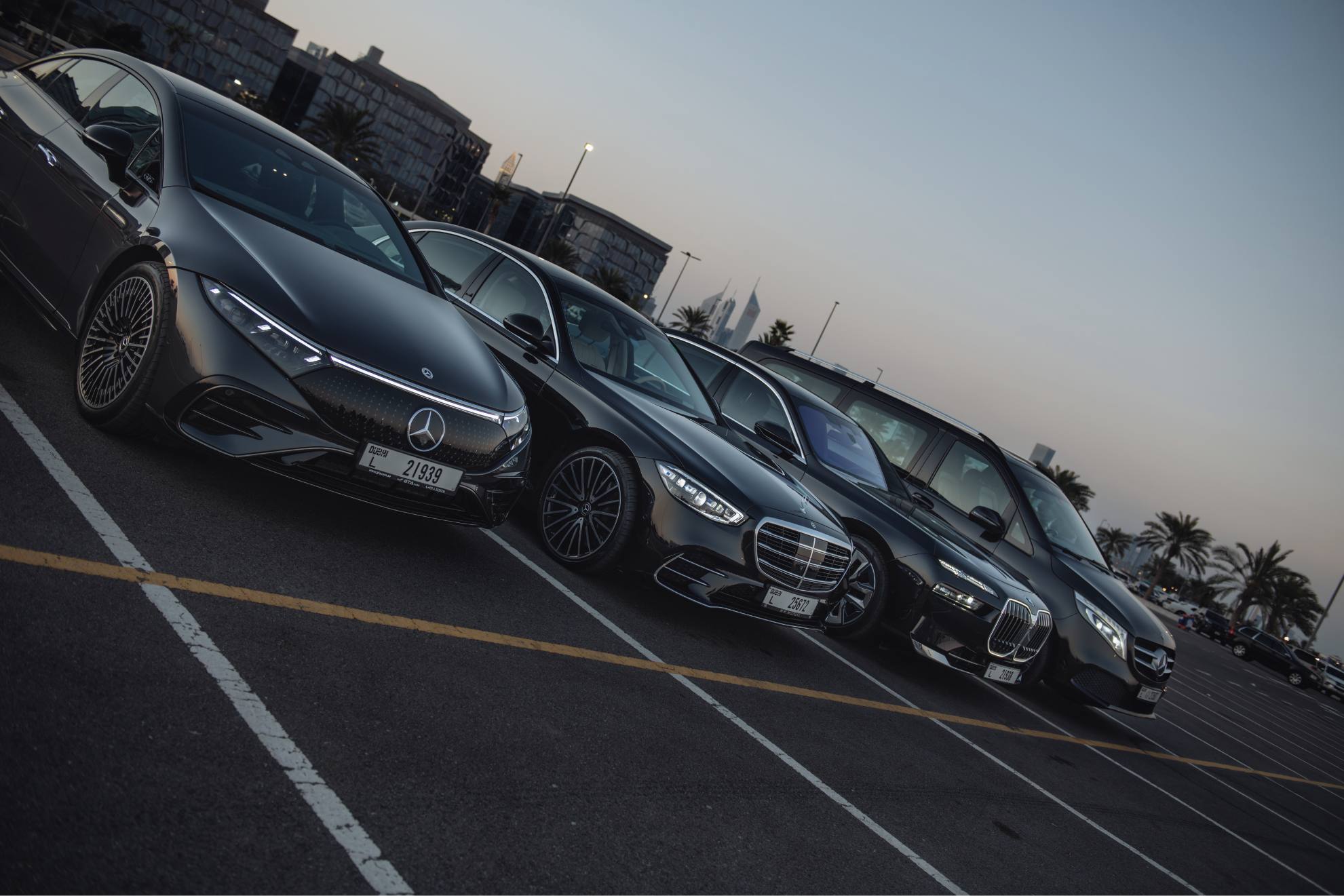 luxury fleet parked in a row in a parking lot
