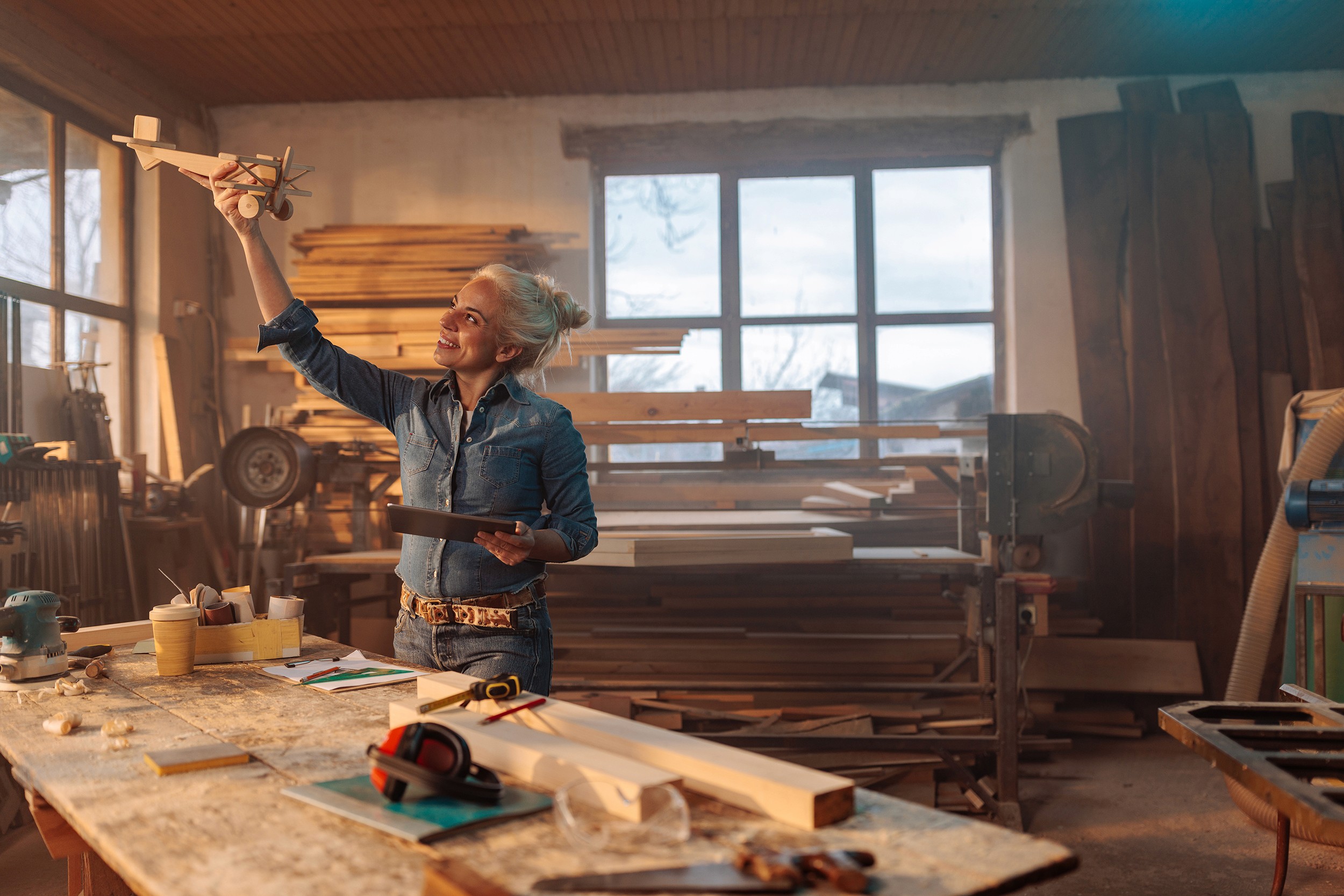 Photo of carpenter testing wooden toy design. 