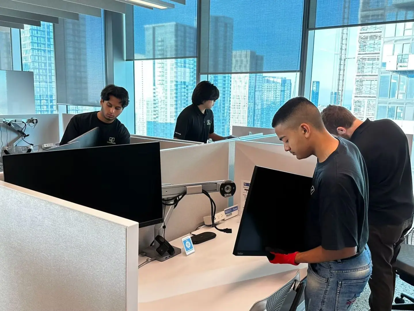 IT and office relocation in progress with cleared workspace, removed equipment, and prepared commercial office interior for technology move and setup