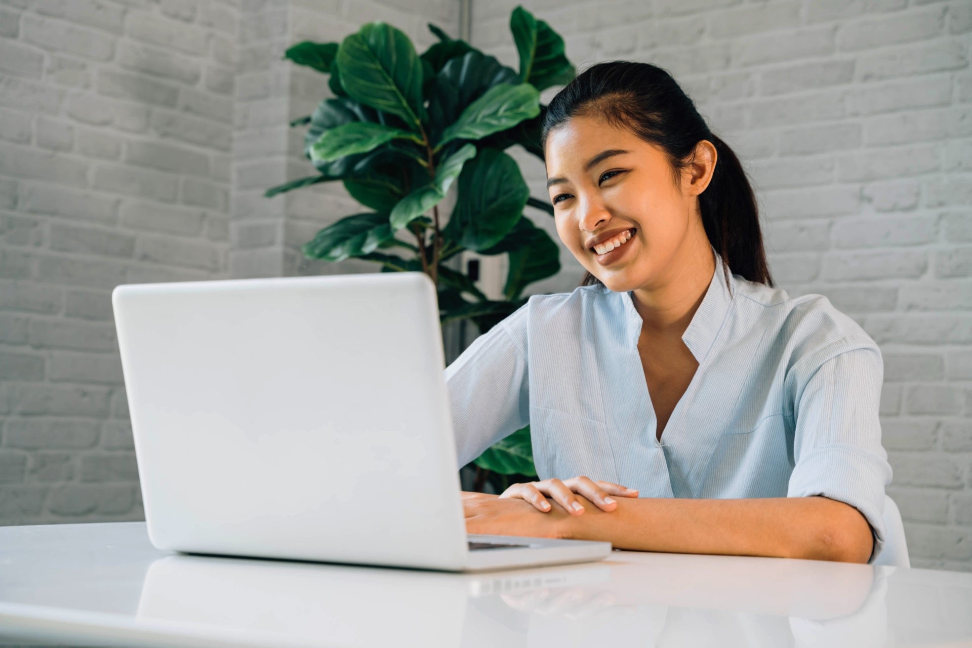 Smiling woman conducting a virtual interview, showcasing a professional and friendly interaction over a video call.