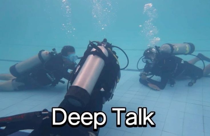 Two scuba divers underwater with an overlaid caption reading 'Deep Talk'