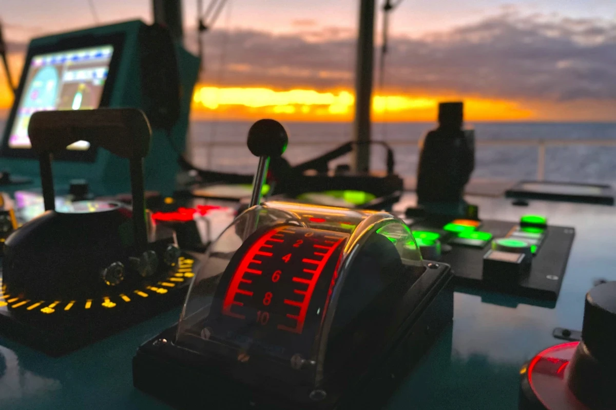 Ship's control panel with sunset background
