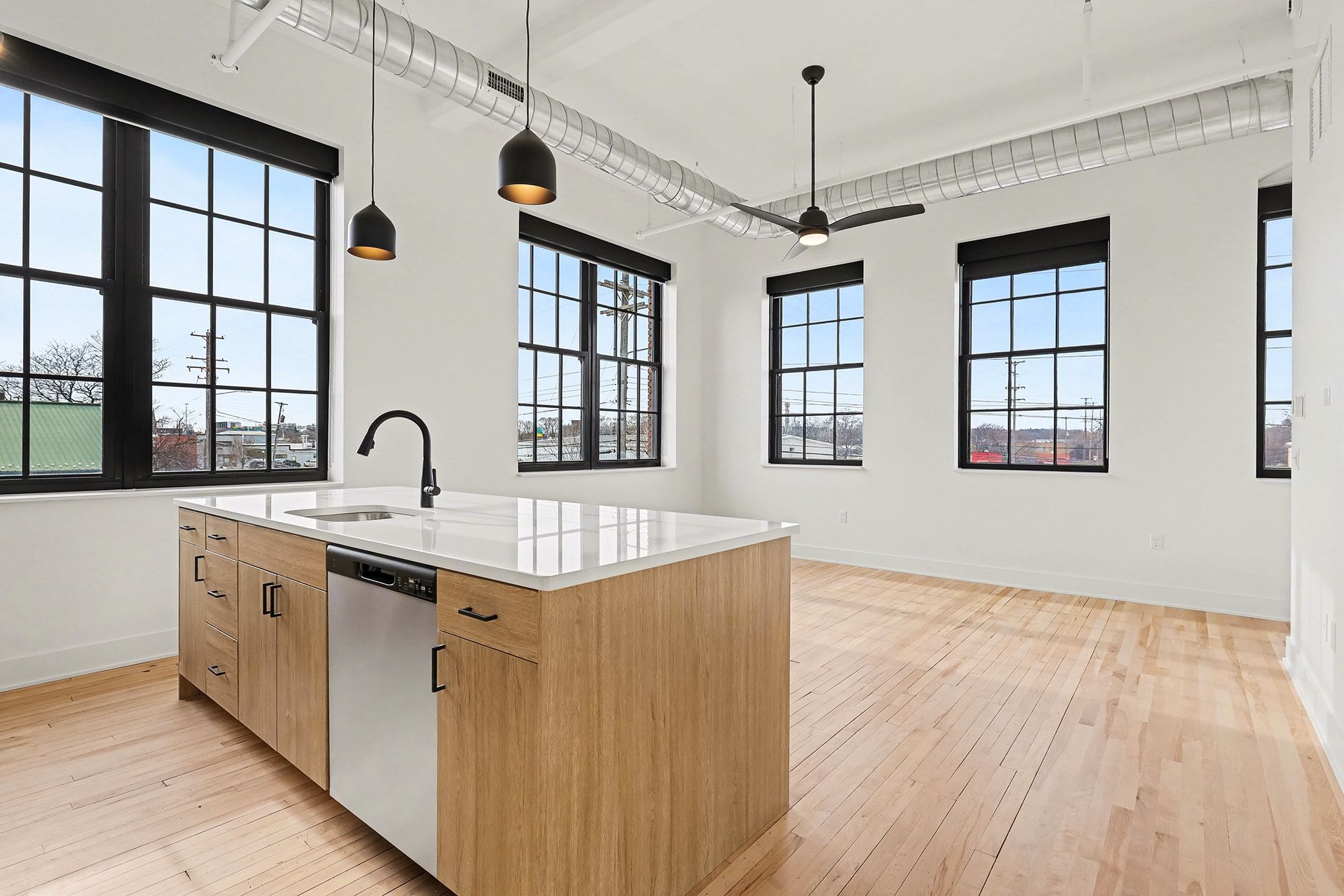 A modern kitchen featuring a bar stool beside a sleek refrigerator, showcasing a clean and organized space.