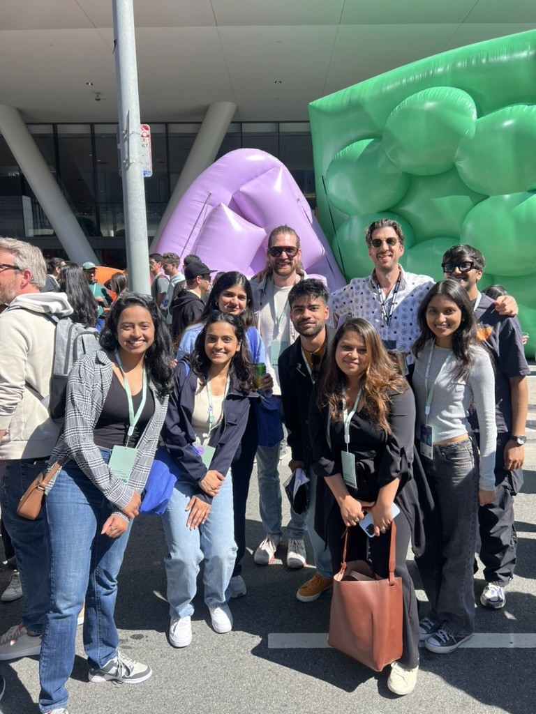 Bright, spacious gallery interior with vaulted white arches, tall windows, and reflective wooden floors