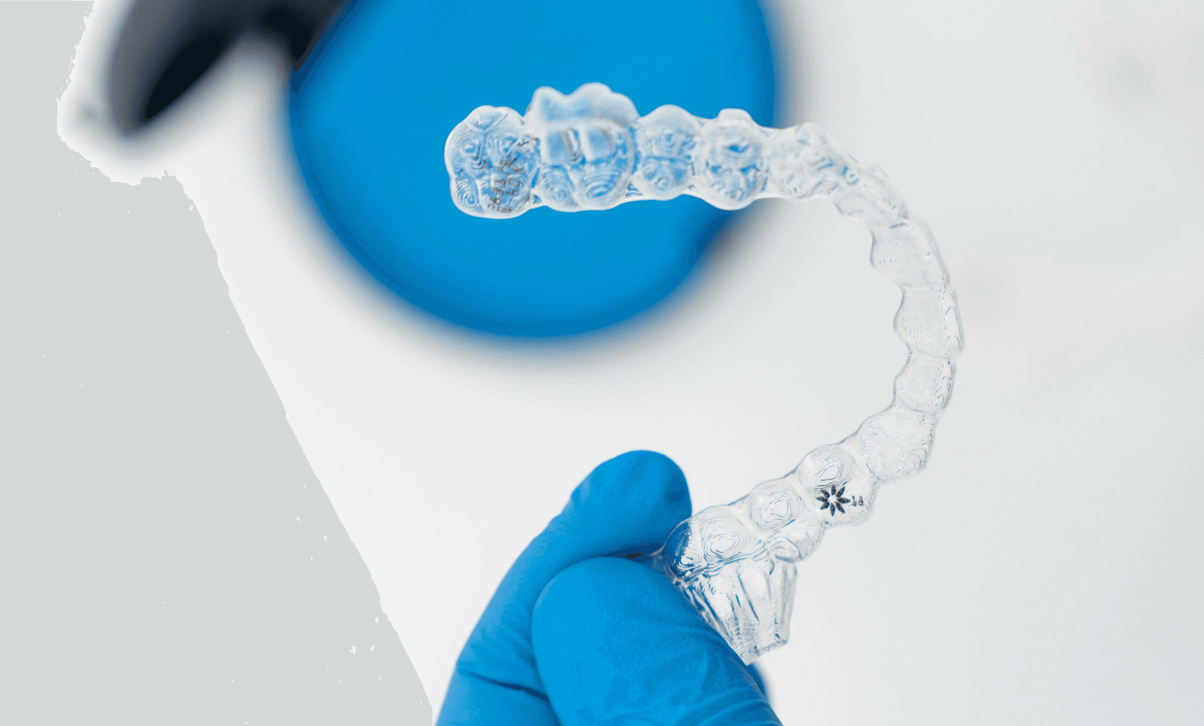 Woman sitting cross-legged on the edge of the bed in darkness