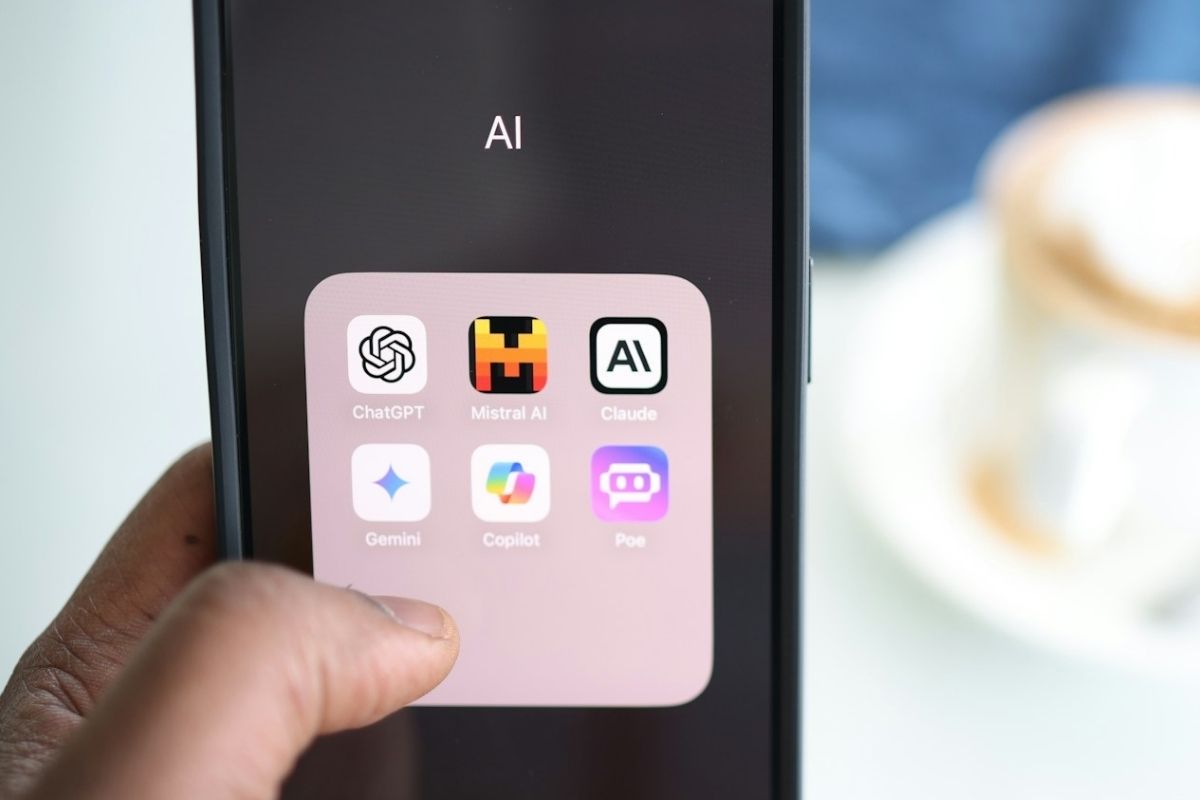 A hand is holding a phone with an image of the logo.
