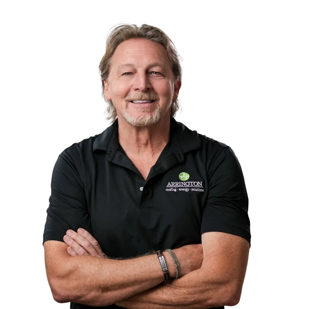 Man in Arrington Roofing shirt with arms crossed smiles