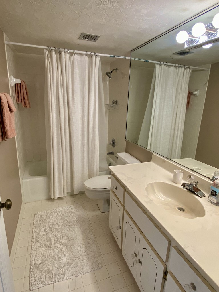 Bathroom with a tub shower and long vanity, Unit 1K at Sandpoint, a vacation rental in Daytona Beach Shores