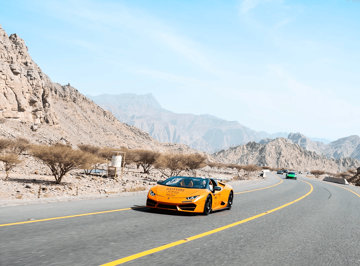 Black-and-white photo of a guitarist playing in a small venue, surrounded by the crowd.