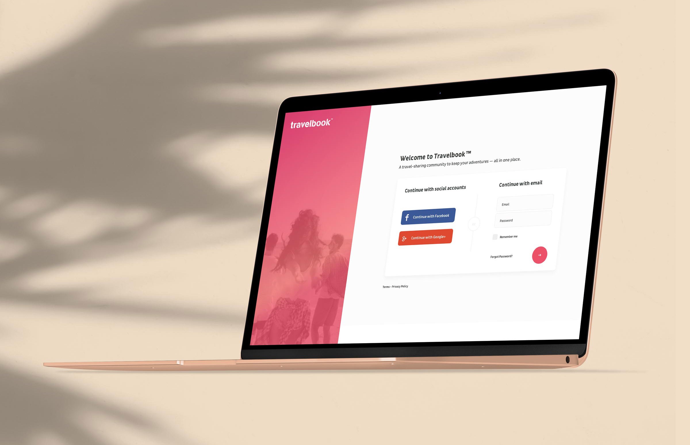 Gold laptop displaying the Travelbook login screen with pink accent branding, set against a beige background with soft palm leaf shadows.