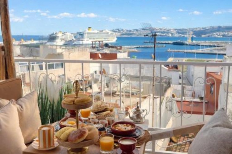 sunloungers fronting buildings near mountain