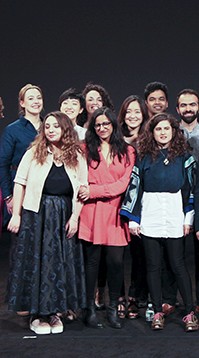 A photo of a group of people standing on a stage.