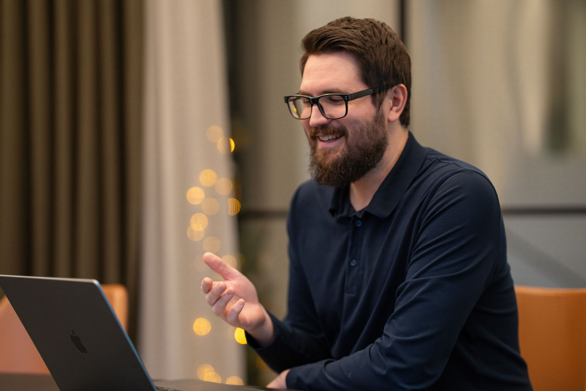 Man smiling while working on his computer