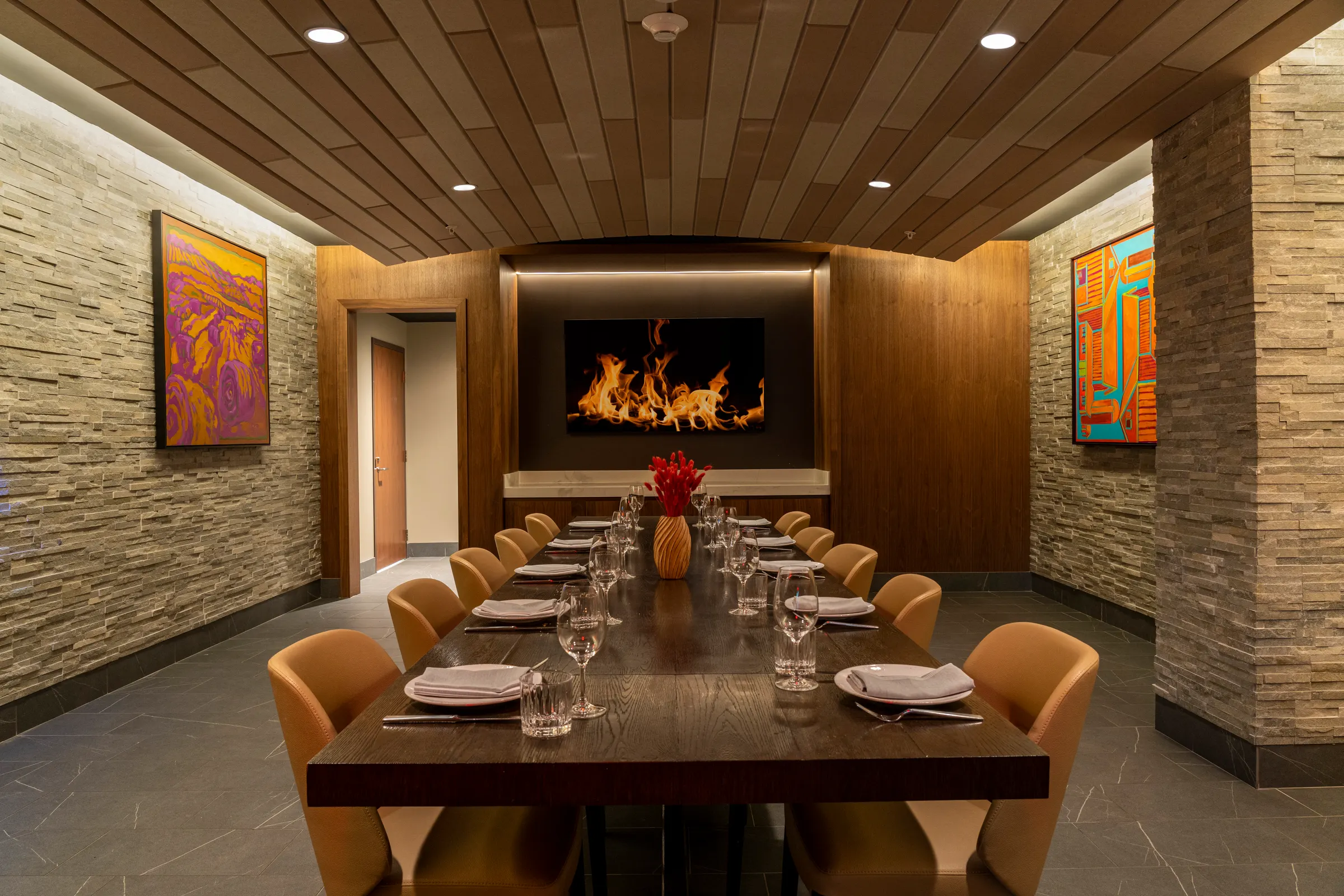 Private dining room with long table and fireplace screen at FYR Short North