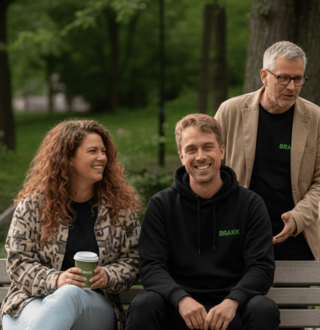 a group of people sitting at a table with laptops