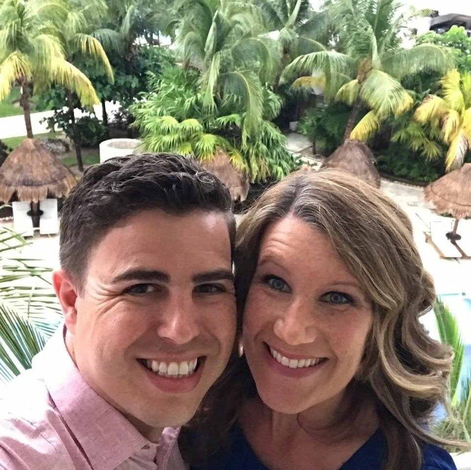 Three men cooking food on an outdoor grill.